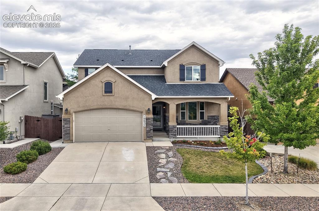 Image 1 of 48: Wonderful stucco and stone home with front porch for sitting and enjoying P