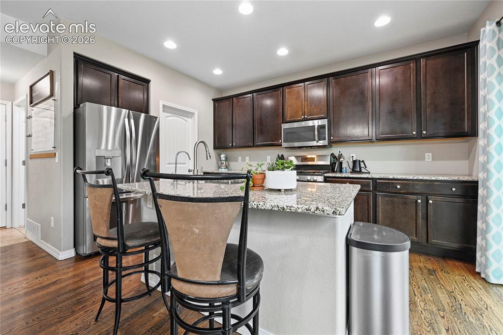 Image 15 of 48: Recessed lighting keeps every corner of this kitchen bright, and the cabine