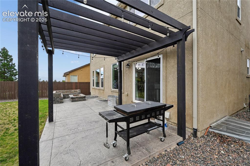 Image 19 of 48: Step outside from the kitchen and your shareable spaces are extended with a