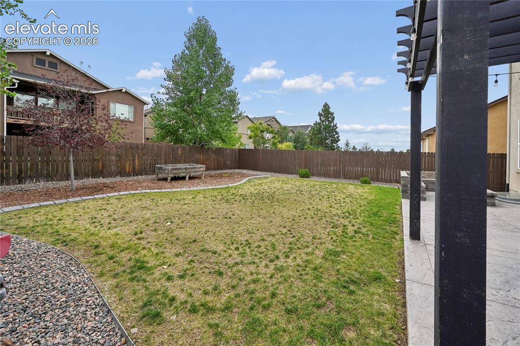 Image 22 of 48: The automatic sprinklers are working to bring back the lawn, while the rais