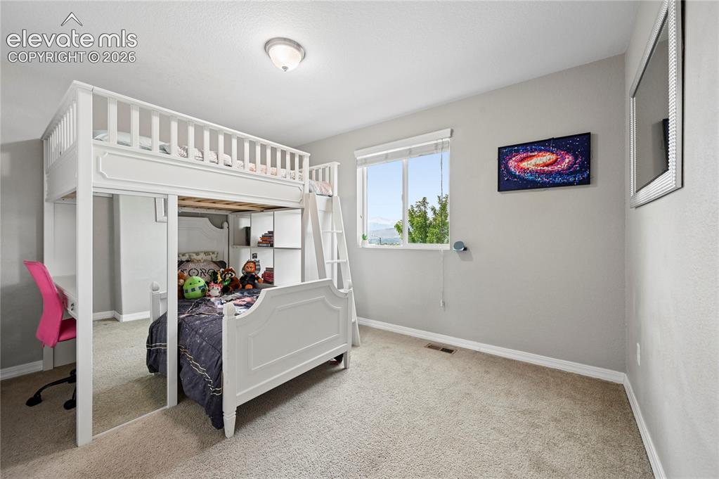Image 33 of 48: Bedroom #2 of 5 is upstairs, and is one of the windows that enjoys the same