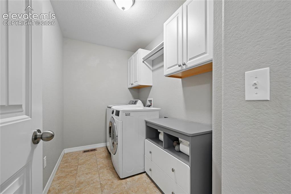 Image 36 of 48: The laundry room is upstairs, and has extra space for folding & storing thi