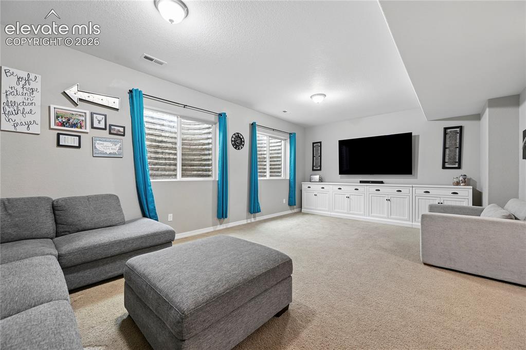 Image 37 of 48: The over-sized family room in the basement with its high ceilings is plenty