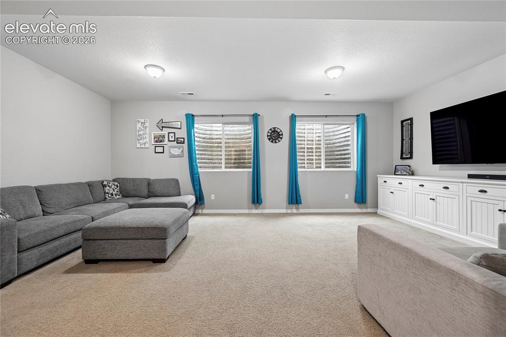 Image 38 of 48: The basement family room makes for a family or common area on all three lev