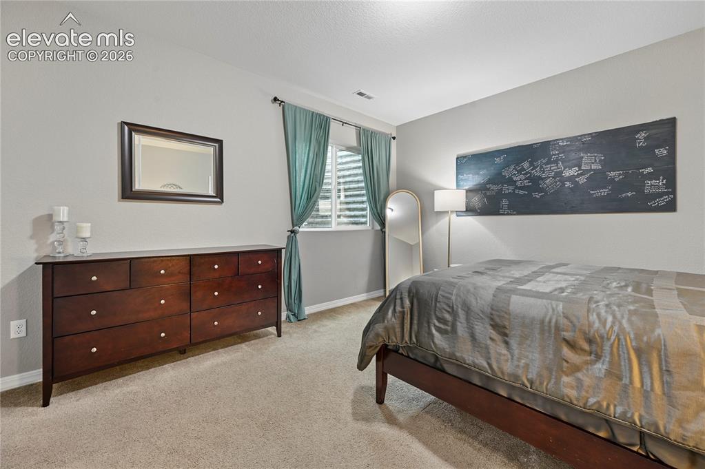 Image 40 of 48: Bedroom #4 of 5 is in the basement and around the corner from a full bathro