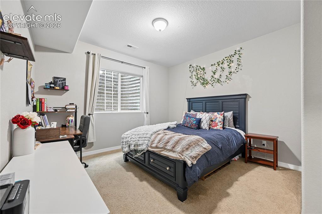 Image 41 of 48: Bedroom #5 is tucked into another corner of the basement, but is big enough