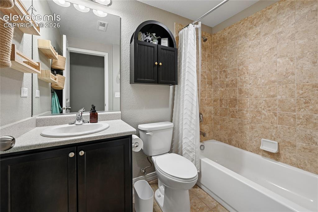 Image 42 of 48: Another full bathroom that is shared by the two basement bedrooms, bringing