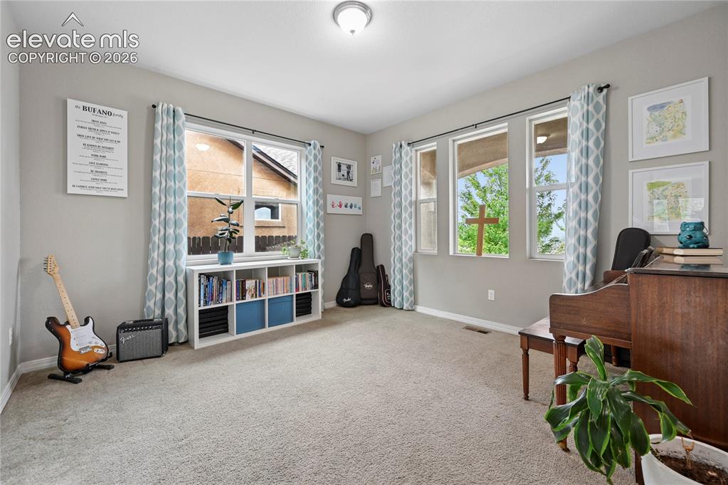 Image 7 of 48: The front room or office just inside the front is great for piano lessons, 
