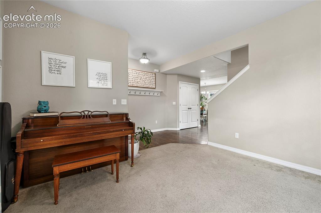 Image 8 of 48: The home office or reading room just inside the front door is nearby the ma