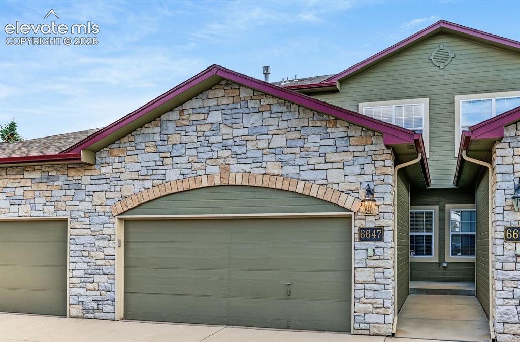 Image 2 of 32: 2-car garage with plenty of guest parking
