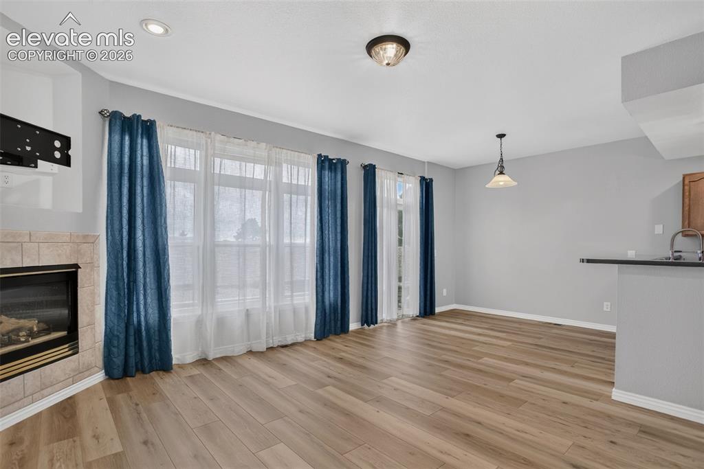 Image 29 of 32: Living space has access to back patio and plenty of natural light