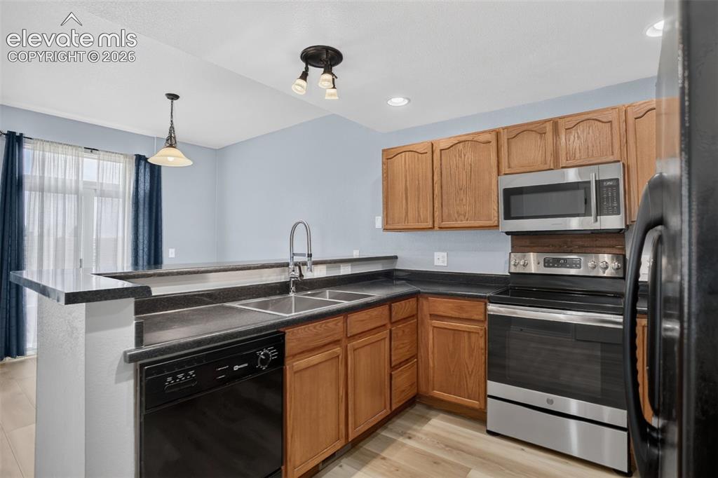 Image 4 of 32: Open floor plan with central kitchen