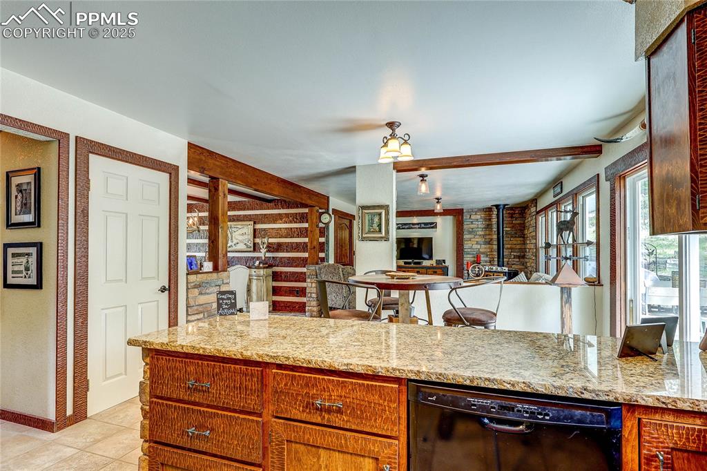 Image 15 of 49: Kitchen with dishwasher, open floor plan, light tile patterned flooring, li