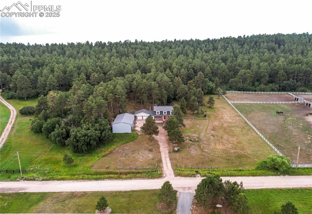 Image 44 of 49: Overview of rural landscape featuring a forest