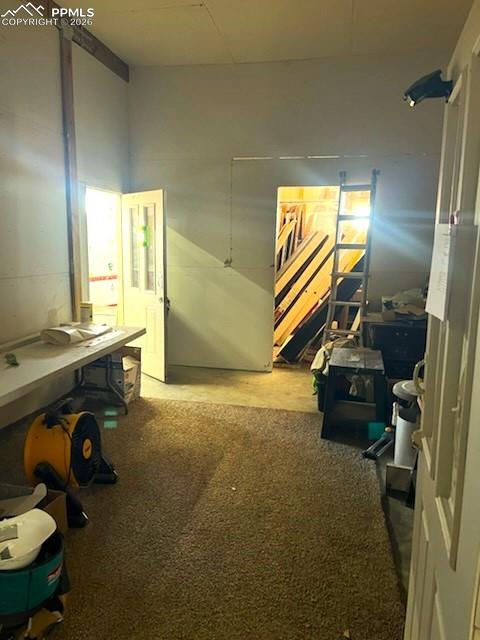 Image 9 of 10: Workroom with storage at back.