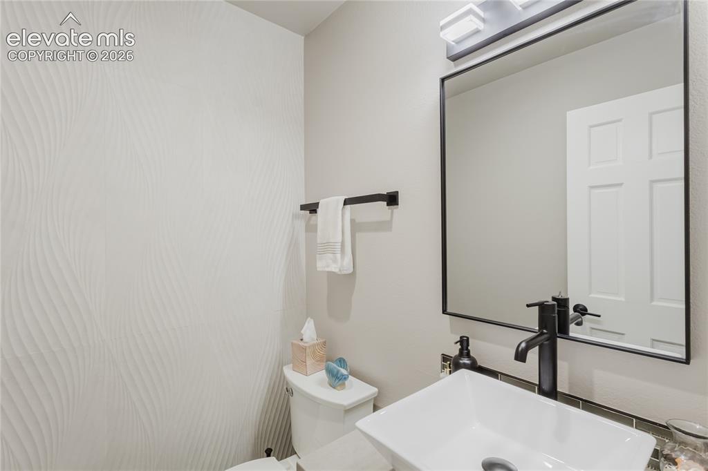 Image 14 of 49: Powder room on main. Check out the gorgeous tile!
