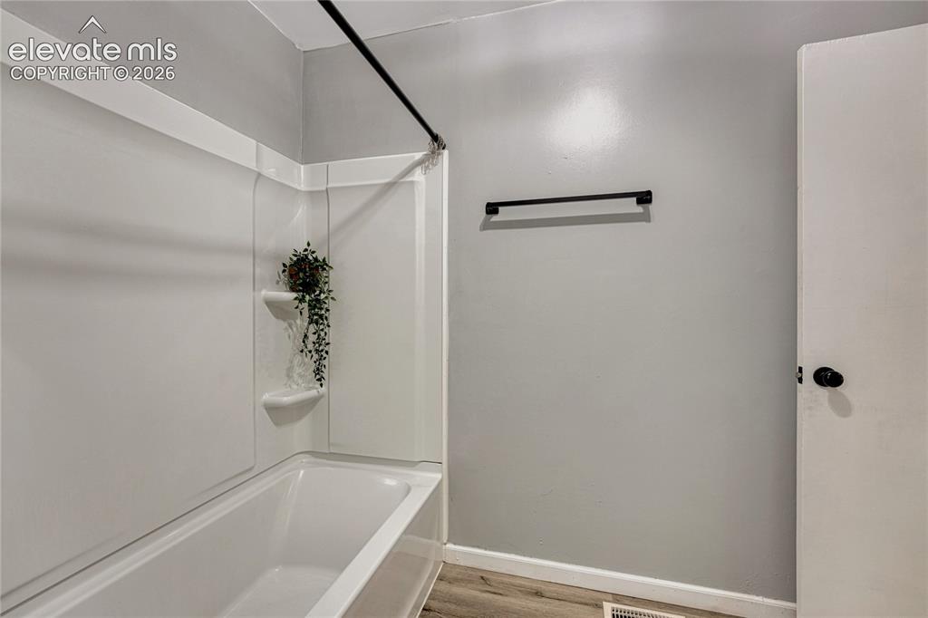 Image 18 of 33: Updated tub/shower insert and new flooring!