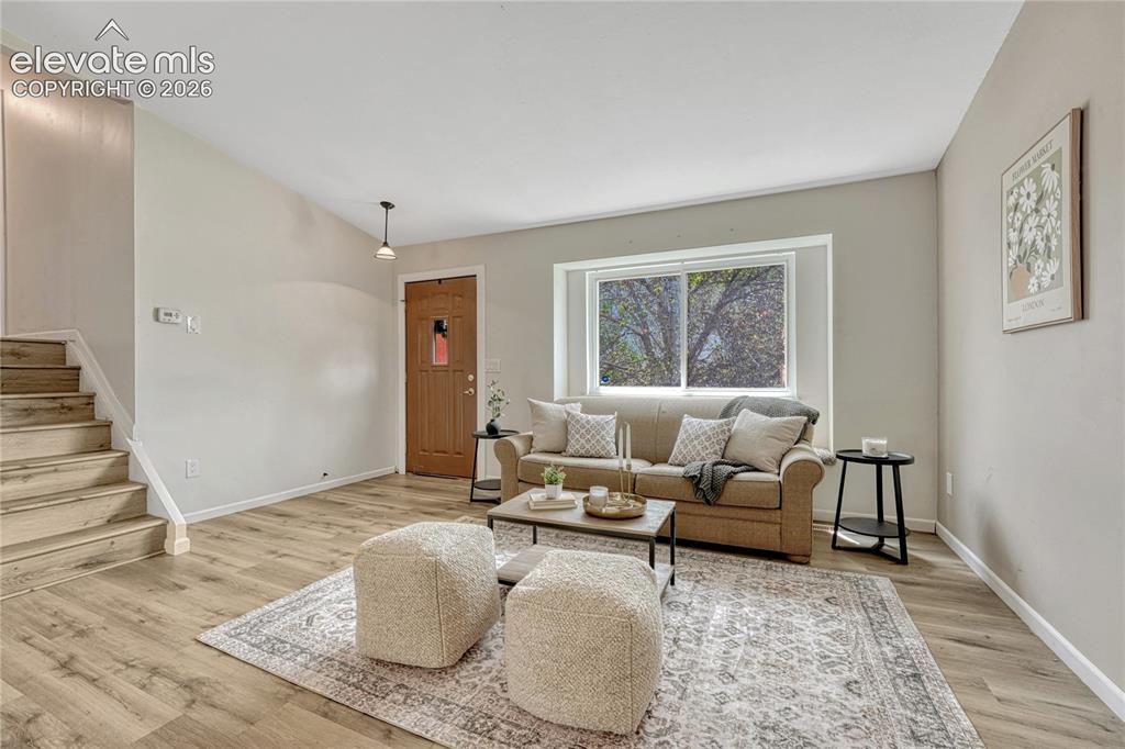Image 3 of 33: Large living room setup and window with a window seat. 