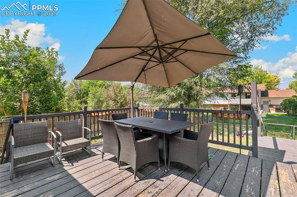 Image 35 of 38: Wooden terrace featuring outdoor dining space