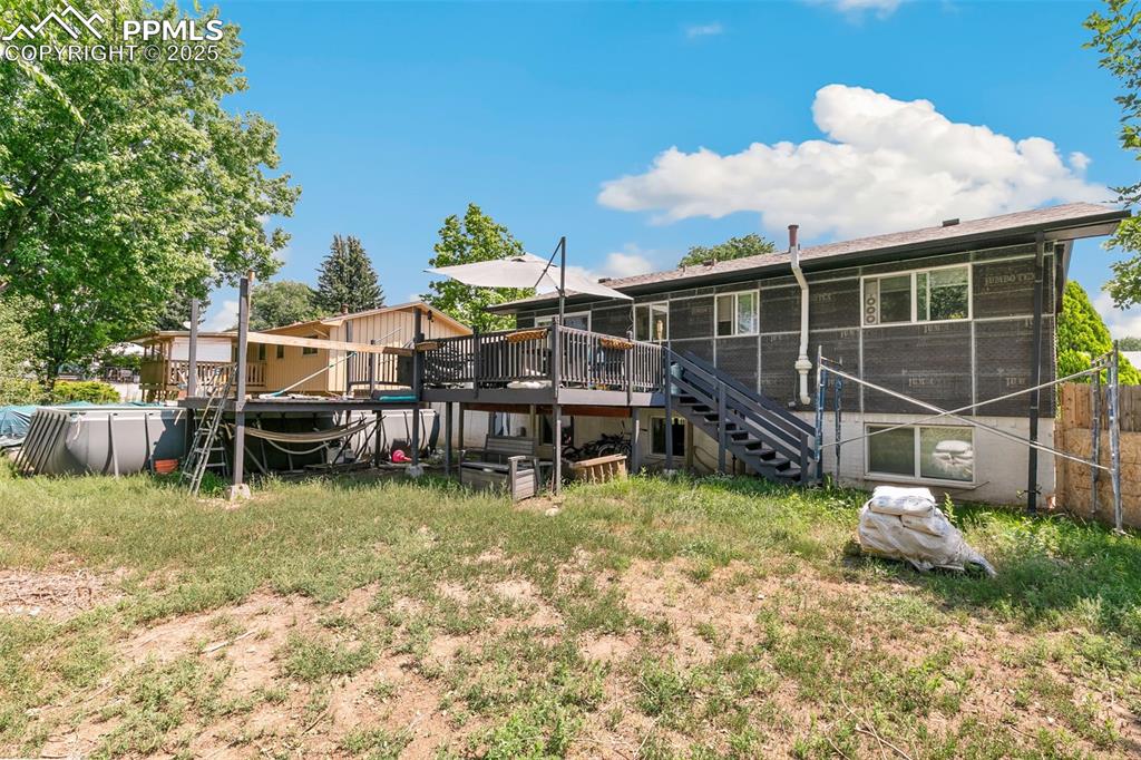 Image 37 of 38: Back of property with a deck and stairs