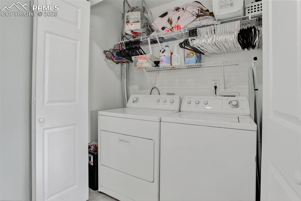Image 13 of 26: Laundry area with separate washer and dryer