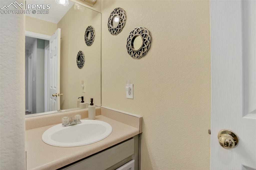 Image 16 of 26: secondary bathroom on upper level with vanity and shower / tub