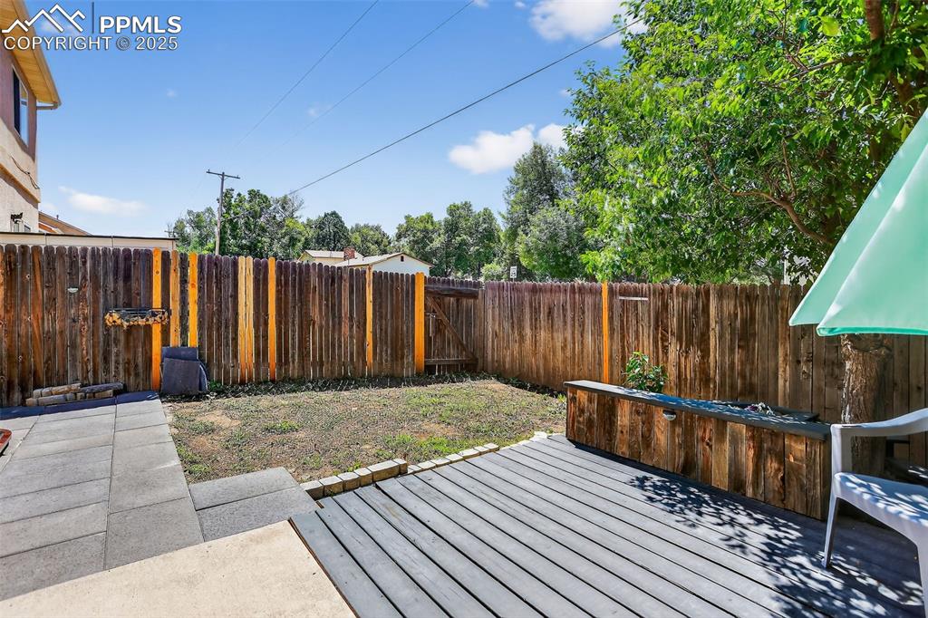 Image 25 of 26: Wooden deck featuring a fenced backyard