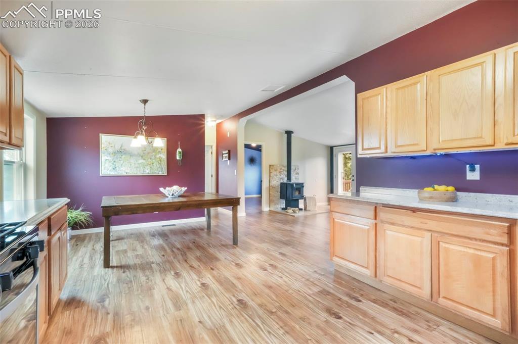 Image 12 of 50: Dining room featuring lofted ceiling, light wood finished floors, and plent