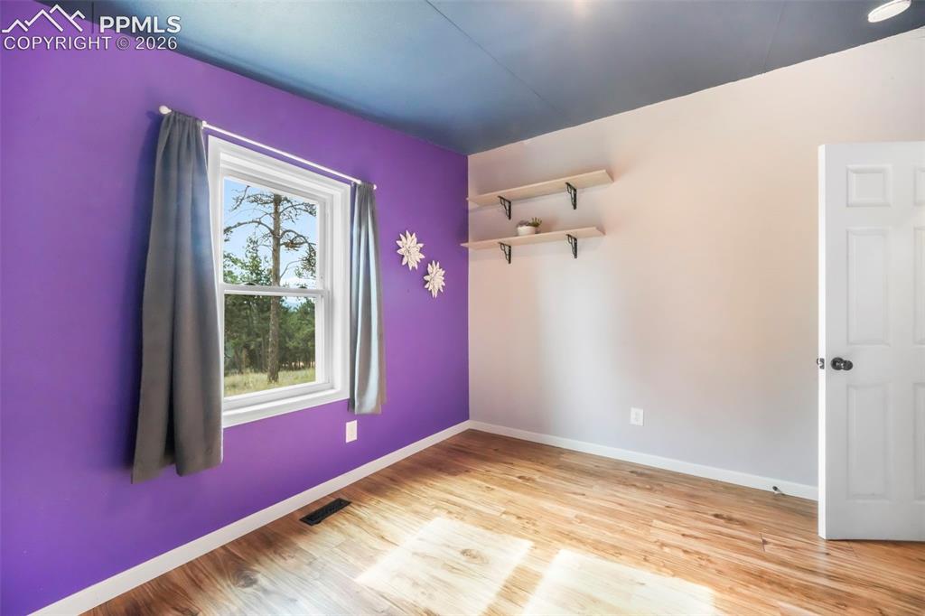 Image 37 of 50: Unfurnished bedroom with light wood-style flooring and a closet
