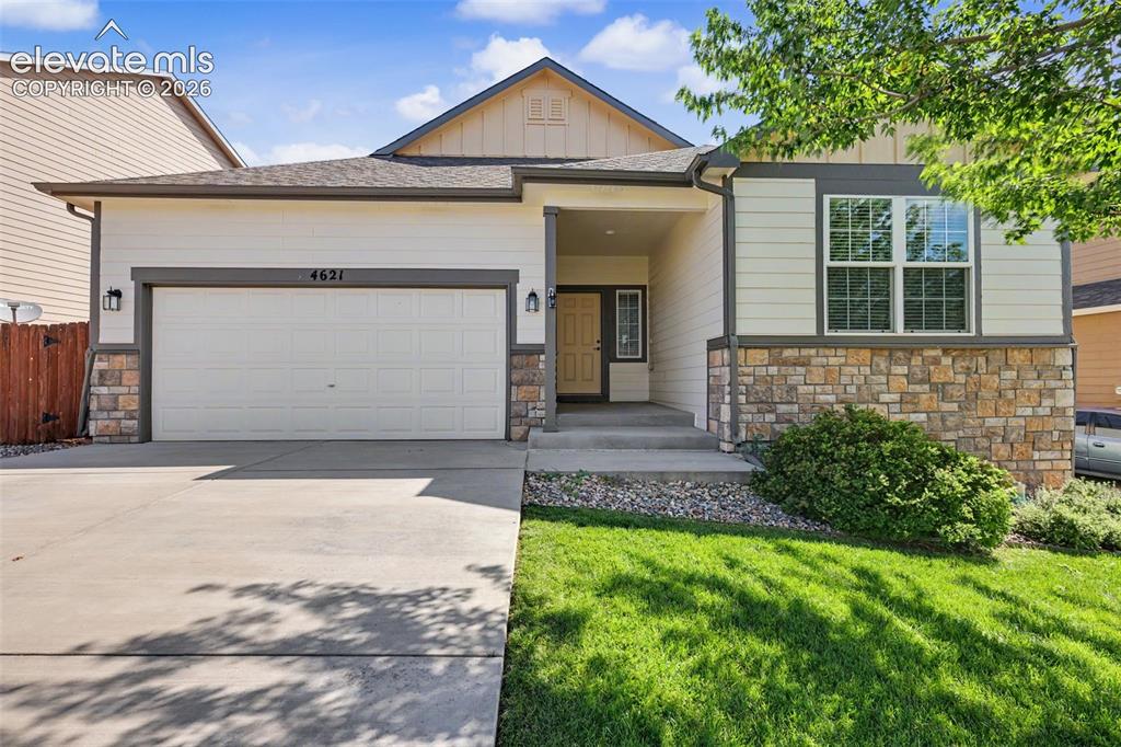 Image 1 of 39: Exterior featuring a two-car garage, stone façade accents, a concrete drive