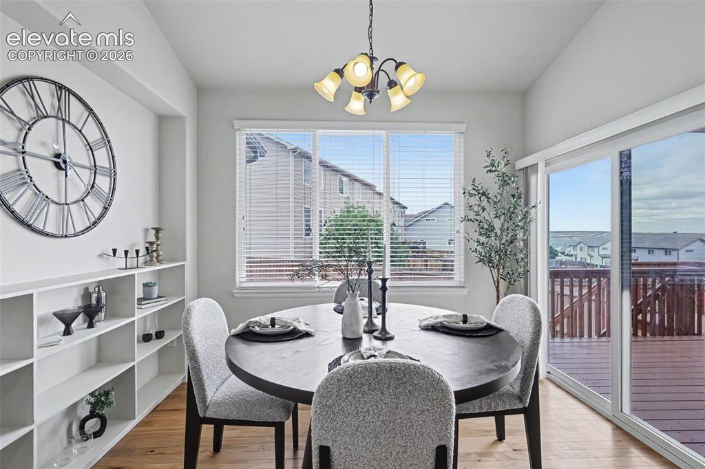 Image 18 of 39: Dining area featuring wood-finish flooring, built-in shelving, and a multi-