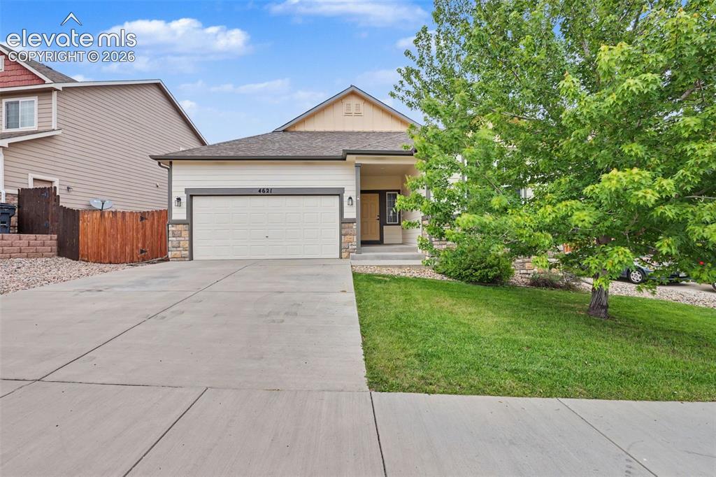 Image 2 of 38: Contemporary ranch-style home featuring a two-car garage, stone and siding