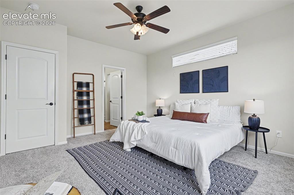 Image 20 of 39: Carpeted interior room featuring light-toned walls, a built-in ceiling fan