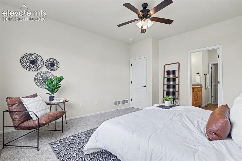 Image 21 of 39: Neutral-toned bedroom featuring a ceiling fan with integrated lighting, sof