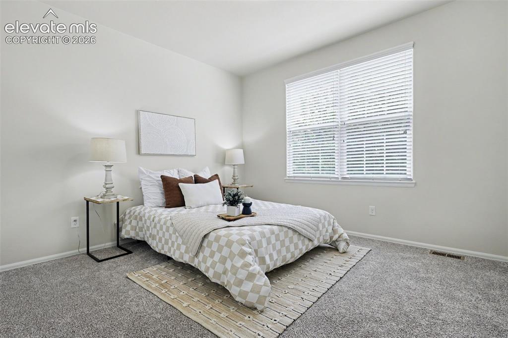 Image 25 of 39: Vaulted ceiling with a large window featuring horizontal blinds