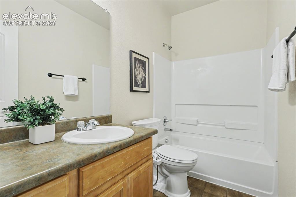 Image 28 of 39: Bathroom featuring a light wood-finish vanity with a single basin, a white