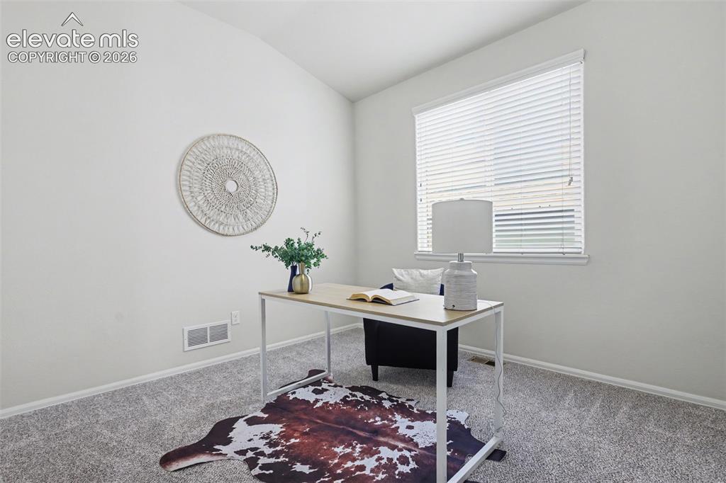 Image 29 of 39: Bright room featuring a window with horizontal blinds, neutral-toned walls,