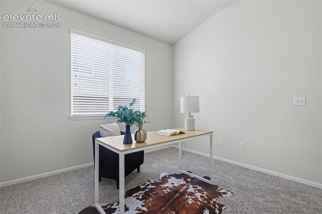 Image 30 of 39: Windowed room with light gray walls and gray carpet flooring