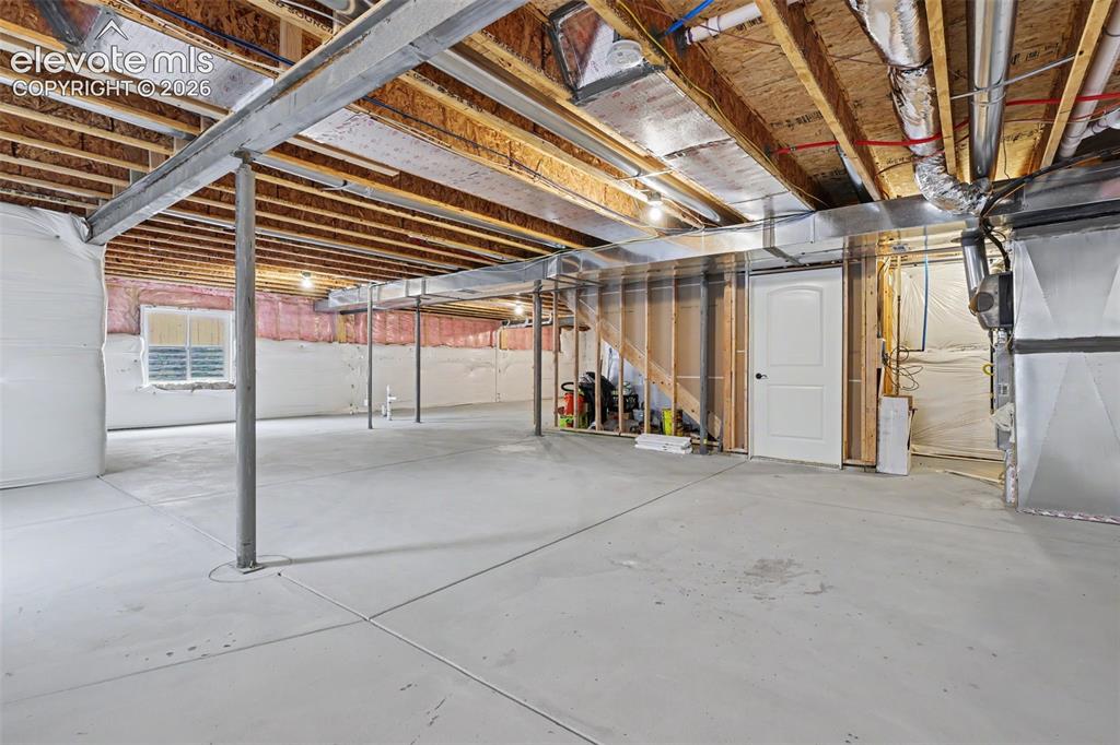 Image 33 of 39: Expansive unfinished basement featuring a concrete floor, exposed wood ceil