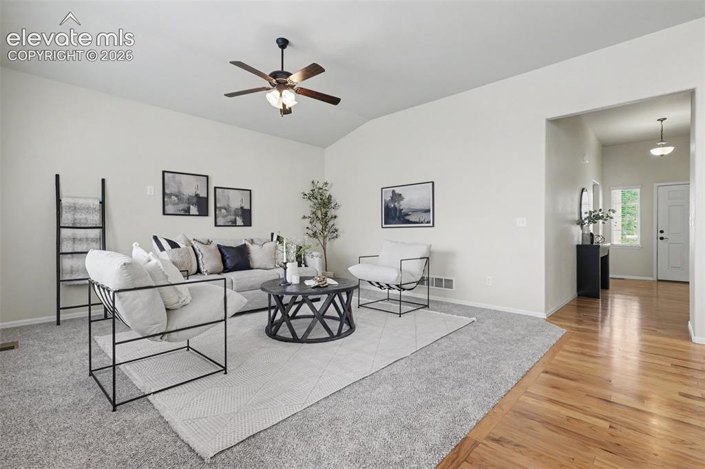 Image 5 of 39: Spacious living area featuring vaulted ceilings, a ceiling fan with integra