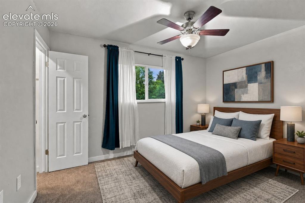 Image 12 of 34: Spacious primary bedroom featuring walk-in closet, carpet flooring, a ceili