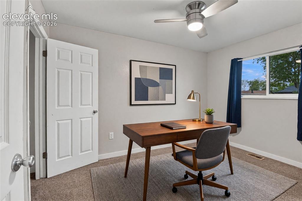 Image 20 of 34: Main level secondary bedroom or home office with a ceiling fan with integra