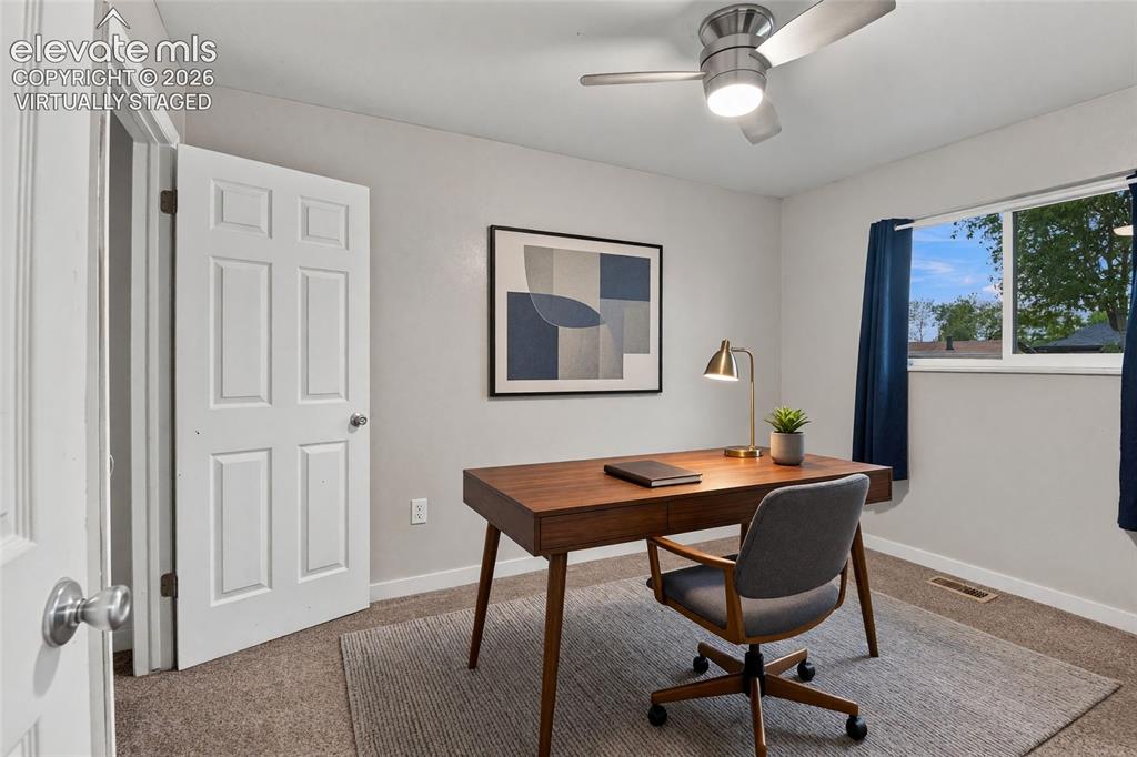 Image 20 of 34: Main level secondary bedroom or home office with a ceiling fan with integra