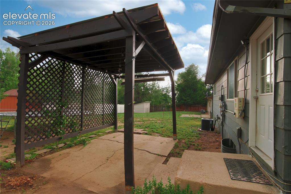 Image 31 of 34: Backdoor into pergola and large backyard