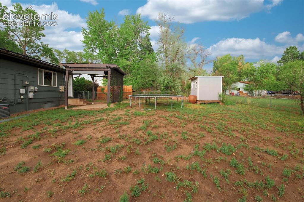 Image 32 of 34: Spacious grounds featuring mature trees, with space for a garden, pets. Inc