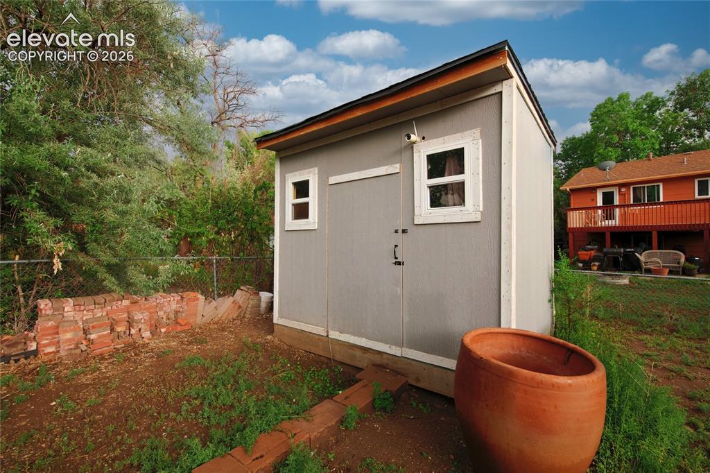 Image 34 of 34: Modern storage shed featuring a gable roof with contrasting trim, horizonta