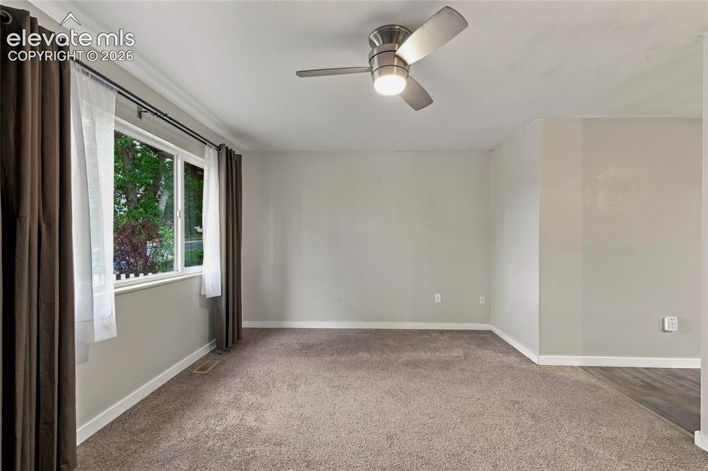 Image 6 of 34: Bright, spacious living room upon entrance, featuring neutral wall finishes