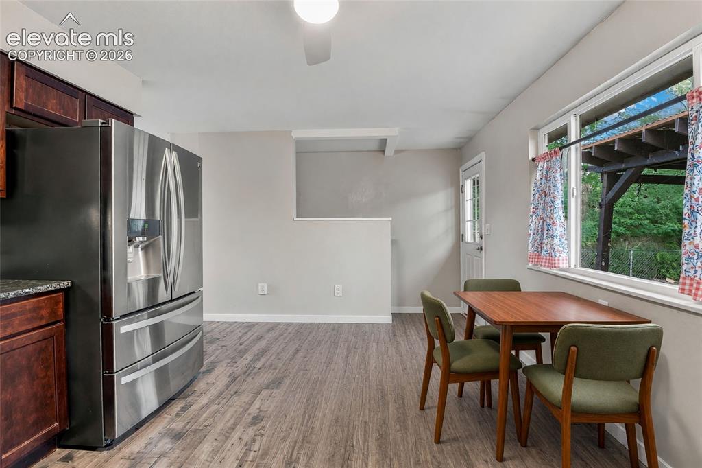 Image 9 of 34: Kitchen with space for dining and walk-out to backyard
