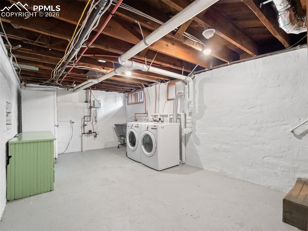 Image 29 of 41: The laundry room includes the original Soap stone sink that has new plumbin