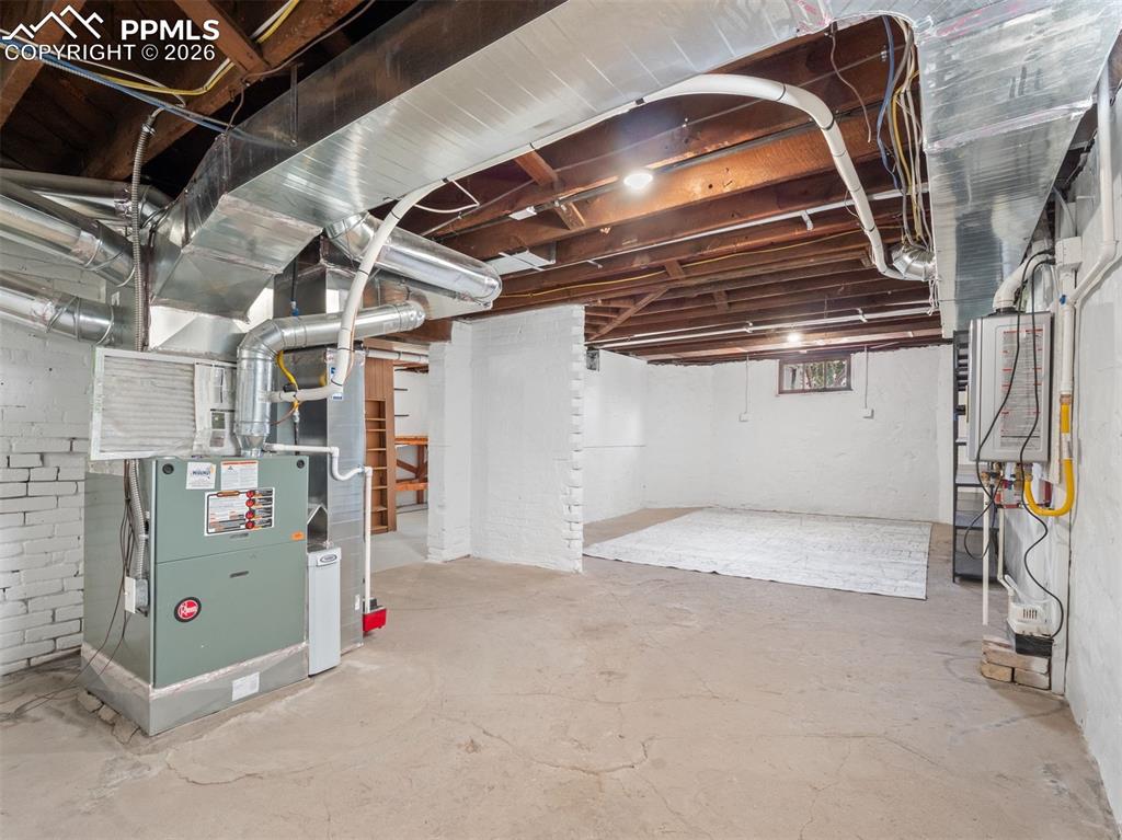 Image 31 of 41: New furnace, ductwork, and tankless hot water heater. Potential to finish a